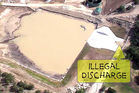 Close shot of the detention pond and illegal discharge.