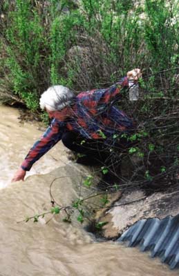 Jim Phillips samples water from the east branch of Lick Creek on April 6, 2004.